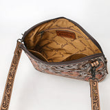 Tooled leather crossbody bag with pink floral carvings, silver scroll accents, and matching tooled leather strap

