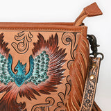 Tooled leather crossbody bag with hand-painted phoenix design, long leather fringe, and floral tooled strap

